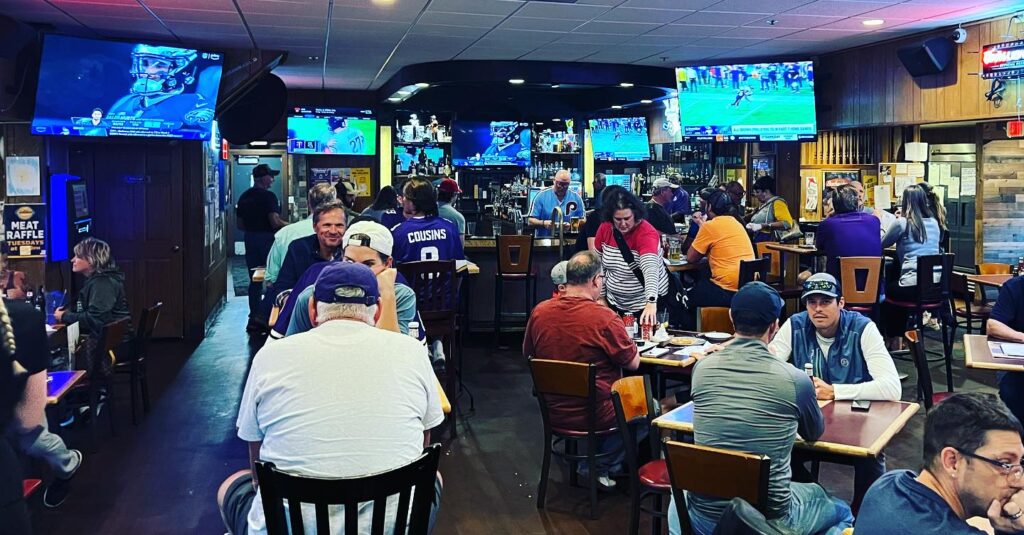 Restaurant patrons dining and watching Vikings football