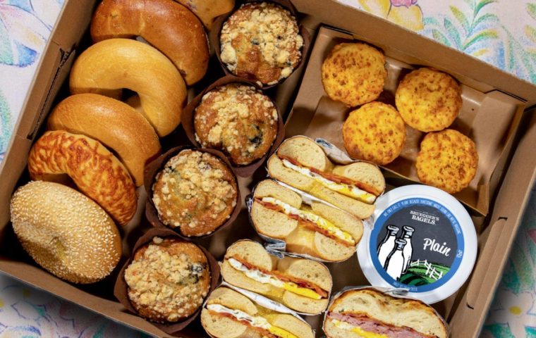Brunch box featuring bagels, muffins, bagel sandwiches and cream cheese