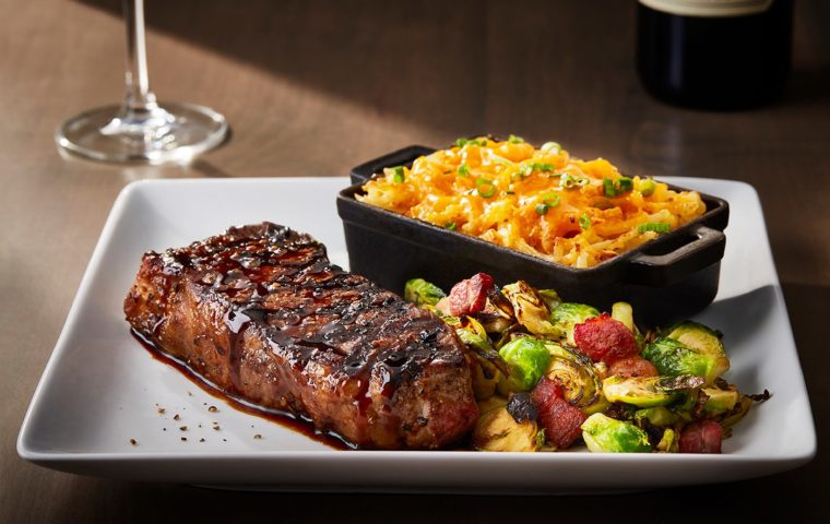 bourbon New York strip steak with brussels sprouts and griddled potato cakes