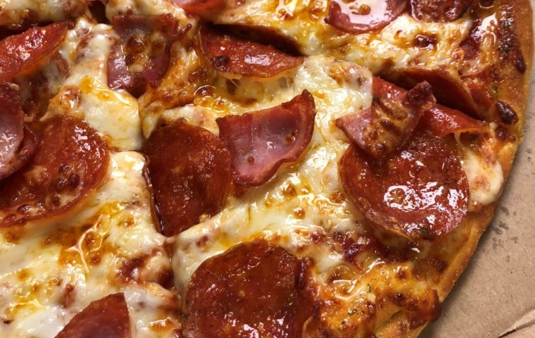 Closeup of pizza with pepperoni and ham
