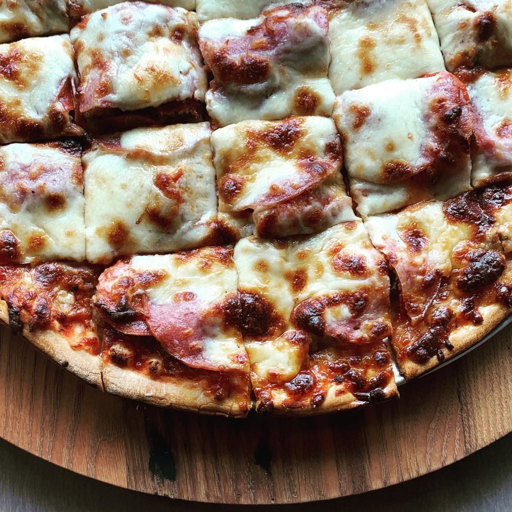 Closeup of a cheese covered pizza with pepperoni