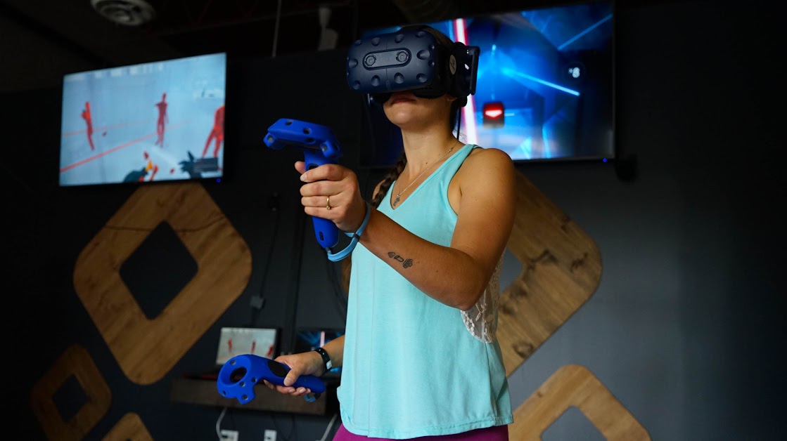 woman wearing VR headset and holding controllers
