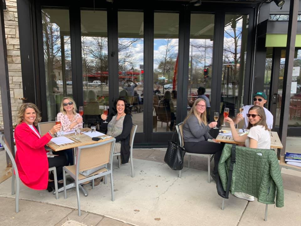 two groups of diners toasting at patio season at Mill Valley Kitchen