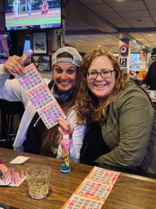 smiling women showing off their bingo card