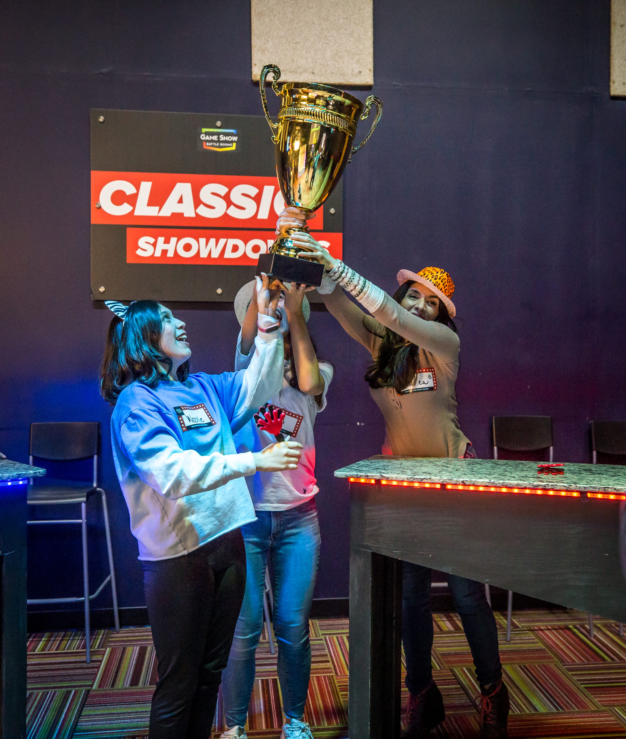 contestants raising a trophy
