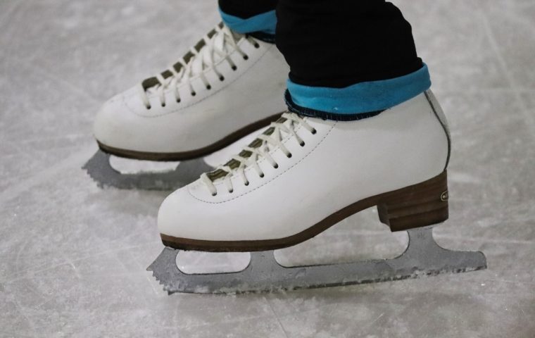 person on ice skates standing on the ice