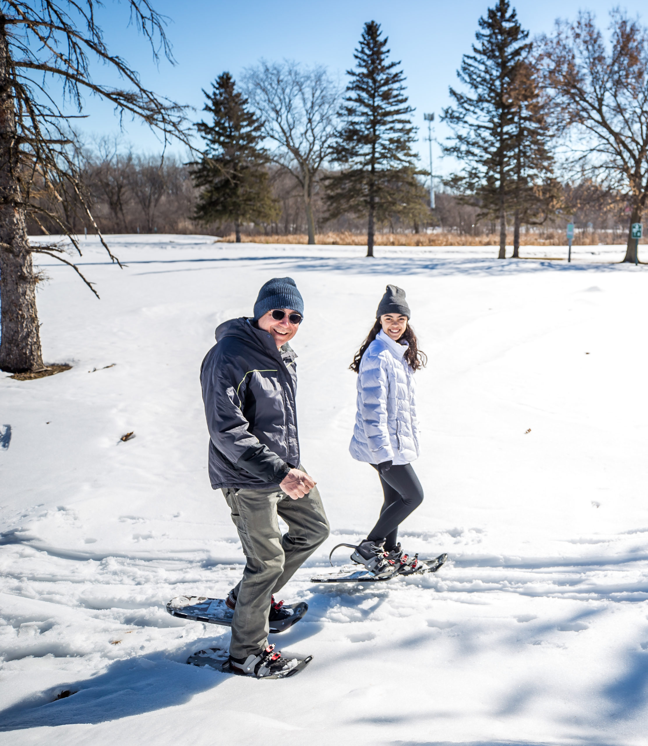 grandfather and granddaughter snowshoeing at Theodore Wirth