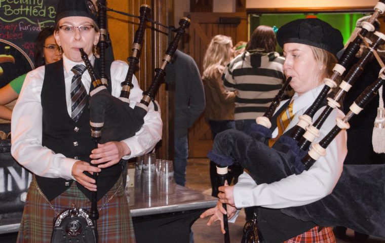 two bagpipers playing at Kips