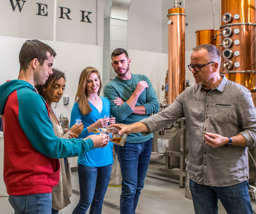 A group of friends having a tour and tasting at Dampfwerk Distillery