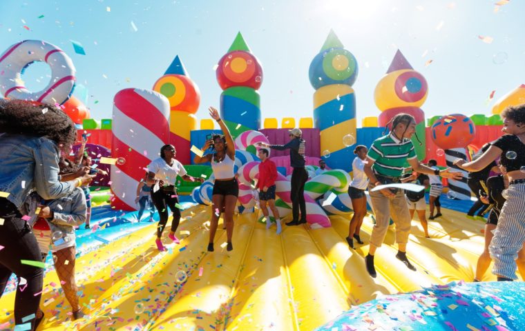 adults and kids bouncing inside the world's largest bouncy house