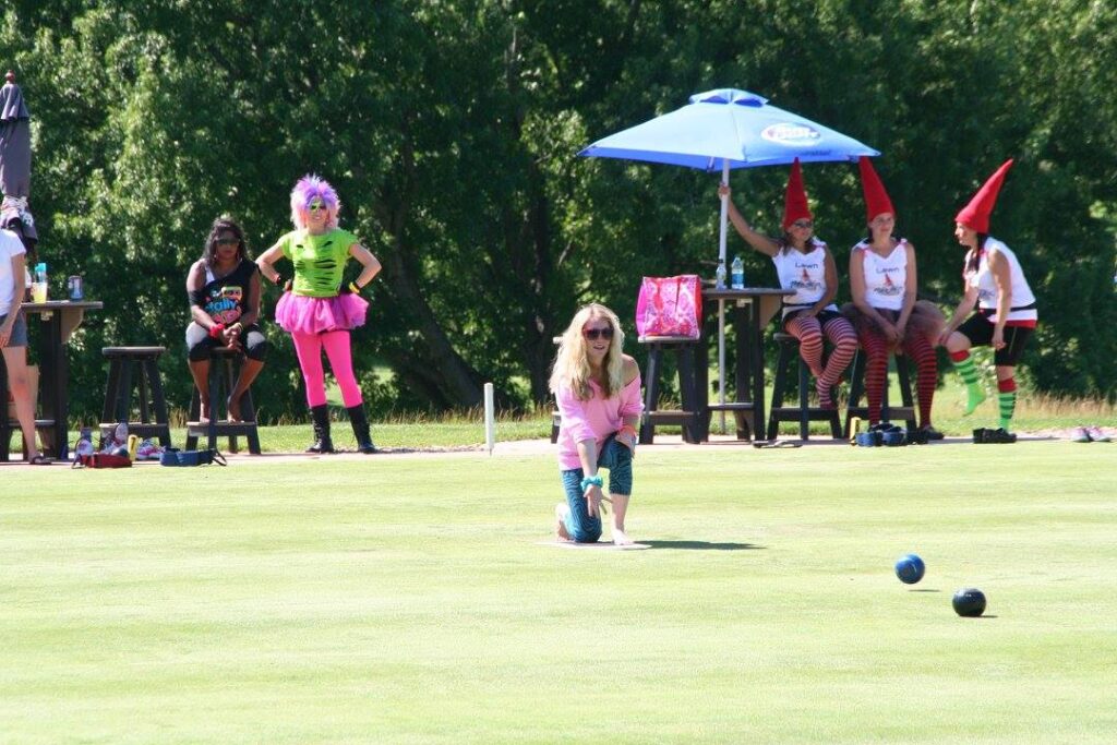 A group of people lawn bowling